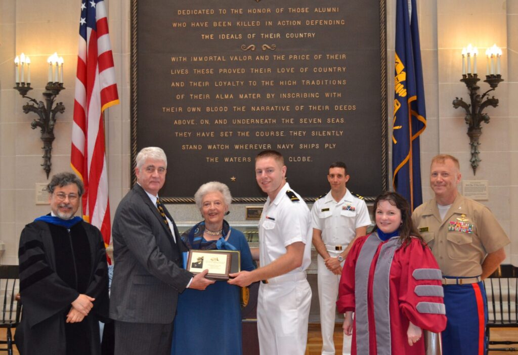 Presentation of the 2013 Beach Award. L to R: XXXXX, Captain Todd Creekman, Ingrid Beach, Midshipman First Class Daniel Ziminski, XXXXXXX, XXXXXXX