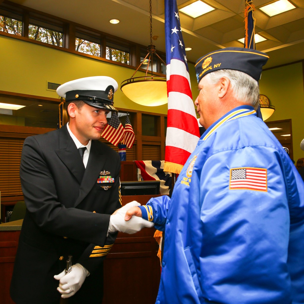 A USS Enterprise (CVN-65) Chief Petty Officer greets Enterprise shipmates at the dedication
