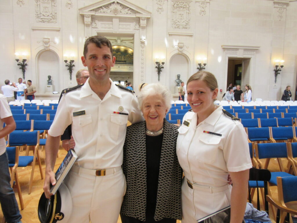 Midshipman First Class Philip Youngberg (left) and Midshipman First Class Dana Petersen (Right) pose for pictures with Mrs. Ingrid Beach at the 2015 Awards Ceremony.