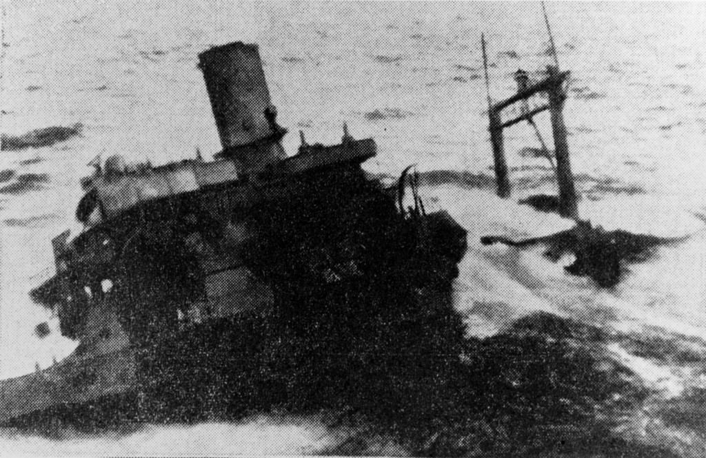 THE WRECKAGE OF THE U.S. NAVY SUPPLY ship Pollux lies aground off the Newfoundland coast, where it foundered in a storm February 18 with many lives lost. The U.S. destroyer Truxtun was wrecked near the same spot during the storm. (AP Wirephoto/NHHC Collection)