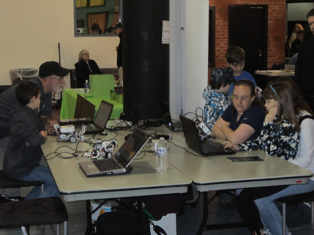 Kids and volunteers use the LEGO EV3 Mindstorms sets during the 2016 LEGO Shipbuilding Event. (Photo by John Paulson/NHF/Released)