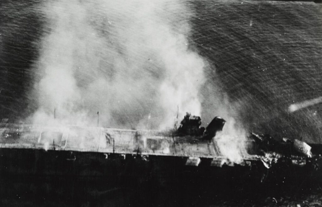 Japanese aircraft carrier Hiryu burning, shortly after sunrise on 5 June 1942, a few hours before she sank. (NHHC Photo # NH 73064)