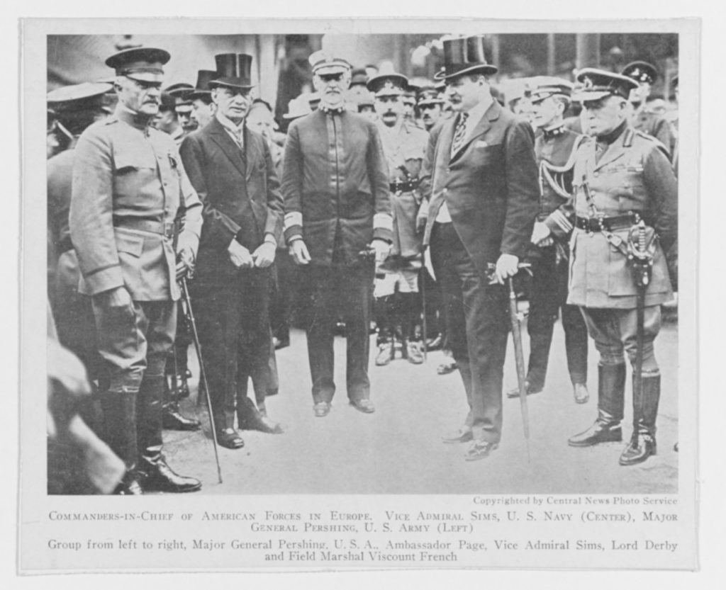 This image was originally taken on 8 June 1917, upon Pershing's arrival. Note that he arrived in three star status and Sims is standing in the uniform he had made which features two stars. Pershing was two years junior to Sims by lineal precedence, but received his promotion to four stars while Sims received his promotion in July to three stars (with the promotion back dated to May according to the register). In essence, Pershing always outranked Sims as the AEF commander, but Sims held the chair as senior naval representative on the Allied Naval Council in London. (NHHC Photo # NH 52790)